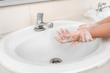 Woman's hands wash their hands with soap cleanse the hands in the tub with soap, personal hygiene