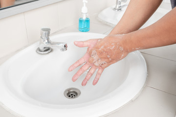 Men's hands wash their hands with soap clean hands in the tub with soap, personal hygiene