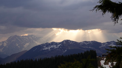 Naklejka na ściany i meble beautiful morning on the mountains with sunbeams and clouds and view to the alps