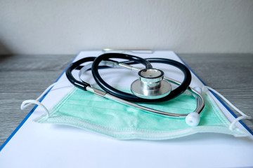 Pictures of medical surgical masks and stethoscope are on the prescription documents in the hospital dispensing room