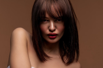 Brunette model on closeup photo posing with very good light and so detailed skin texture after high end retouching
