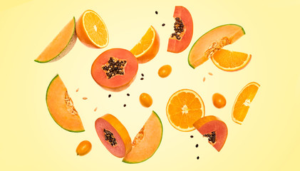 Flying fruits healthy summer background. Papaya, orange, melon. Levitation, falling fly fruit. Tropical creative concept. Colorful fruity summertime orange vivid design