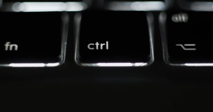 Pressing control ctrl key on a computer laptop notebook keyboard close-up macro