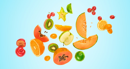 Flying fruits healthy summer background. Papaya, orange, kiwi, melon. Levitation, falling fly fruit on blue. Tropical creative concept. Colorful fruity summertime vivid design