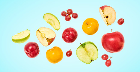 Fototapeta na wymiar Flying Fruits healthy food summer color background. Apple, plum, grape. Colorful levitation, falling fly fruit creative vitamin concept. Colorful fruity summertime vivid design