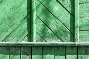 Vintage background green color from wooden batten. Old wood slats paint cracks.