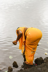 Hindu woman performs a lakeside puja, Mauritius.
