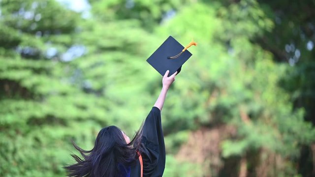 A female university graduate threw a hat to celebrate the graduation day.