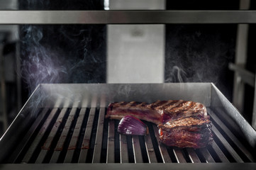 cooking steak on the kitchen grill