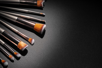 Collection of make up brushes on black background, close up