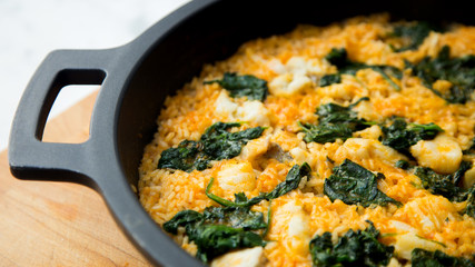 Paella with spinach and seafood