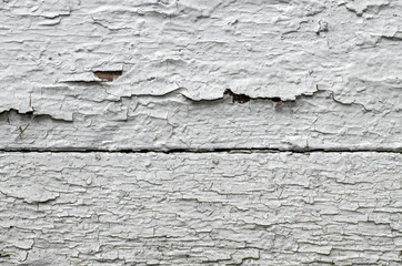 White wooden surface with peeling paint. Decay concept