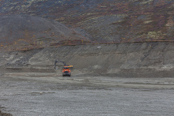Fototapeta premium Construction machinery works on quarry mining in the Khibiny mountains, Kola Peninsula