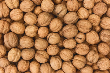 Walnuts background, pile of nuts texture