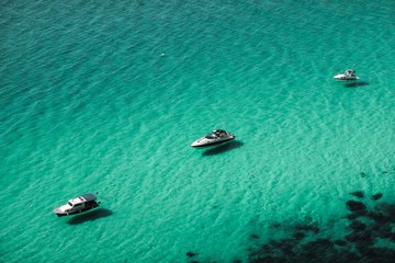 Three boats on turquoise sea