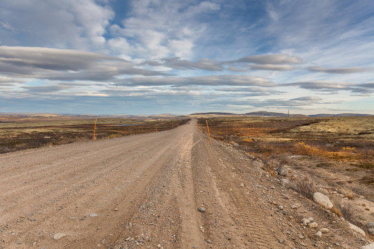 Gravel road to Teriberka in northern tundra landscape of Kola Peninsula. Natural scenery in autumn season. Murmansk Oblast, Russia © Tatiana
