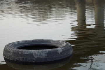 river life buoy wheel in the river river trash