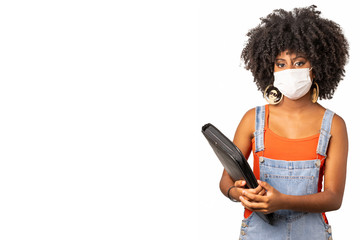mulher adolescente negra usando mascara de proteção facial segura seus livro em volta as aulas