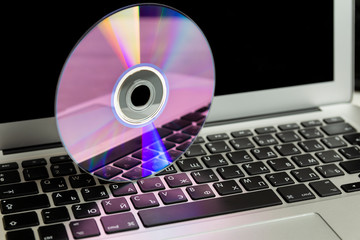laptop and cd on keyboard