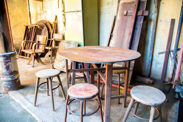 Old chairs and old table in ancient brick house