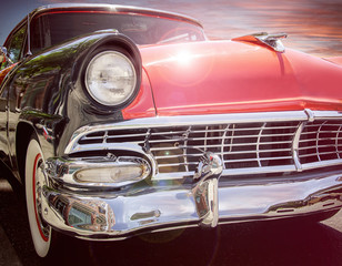 classic 1950s style car with sunset