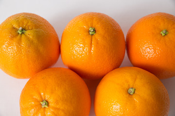Group of whole orange fruits isolated on white background. Top view, closeup. Natural vitamin or organic food concept