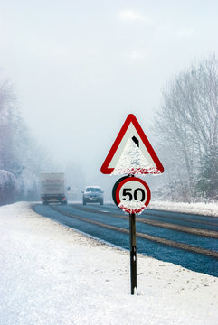 Snowy road with traffic sign and heavy snowfall on a country road. UK