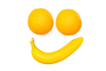 Smiling face banana and oranges on a white background