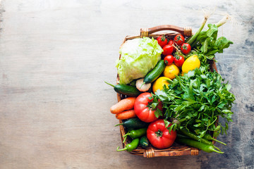 Vegetables in the basket organic vegetables on wooden background