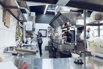 Behind the scenes of brands. The chef cooking in a professional kitchen of a restaurant meal for...
