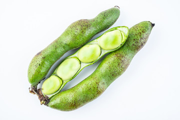 Closeup of fresh broad beans peeled on white background