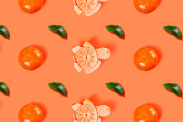 Mandarin pattern on bright orange background. Minimal flat lay concept.