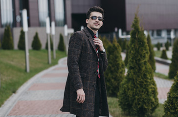 successful handsome man with glasses and a coat. businessman