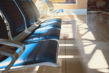 Empty seats in the departure zone. View of airport interoir. Transportation, business travel and vacation theme concept