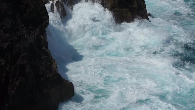 Severe turbulent ocean water during it tide up-down and beating with the cliff of "Angel Billabong", the amazing landmark and travel destination of Bali - Indonesia. Nature phenomenon footage.