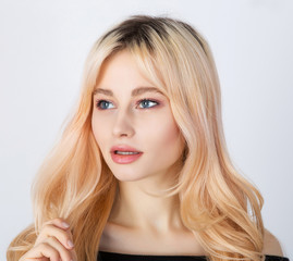 Portrait of a blond girl with dark roots.