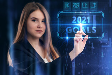 Business, Technology, Internet and network concept. Young businessman working on a virtual screen of the future and sees the inscription: 2021 goals