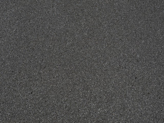 Black micro sponge texture. Soft rubber material background with a high resolution suitable for graphic, top view.