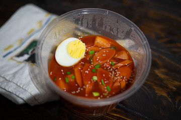 Take out Korean food Stir-fried Rice Cake Tteok-bokki in microwaveable container.