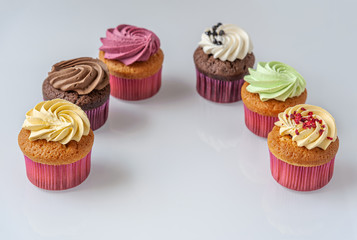 different cupcakes on a light glass surface