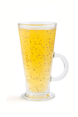 Glass of tangerine orange colored drink with basil seeds isolated on white background. Side view.