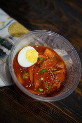 Take out Korean food Stir-fried Rice Cake Tteok-bokki in microwaveable container.