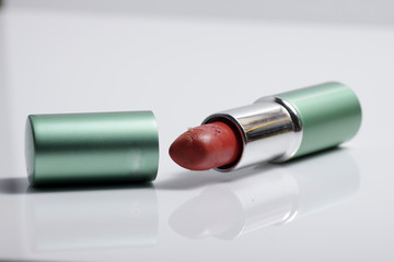 Close up shot of red lipstick on a white background