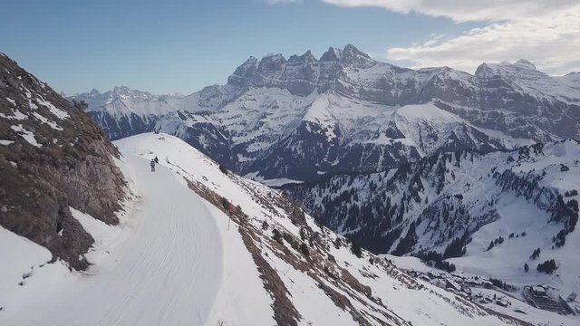 Aerial - Drone follow shot of skier at the skislope on the mountains of Portes Du Soleil in 4K