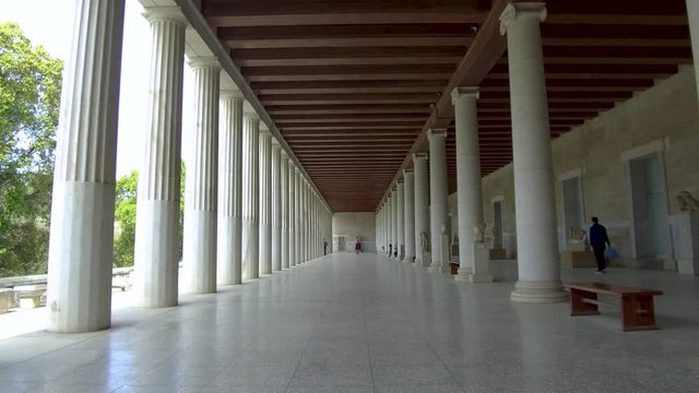 Tracking shot camera moves slowly forward in the interior length of Stoa of Attalos in Athens