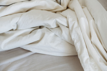 Fototapeta na wymiar crumpled white bedding.white background