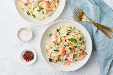 Salmon pasta, tagliatelle with fish and creamy sauce. Italian dinner with seafood