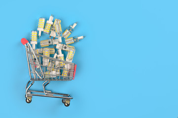 .Energy-saving ice lamps in a shopping basket. Concept of buying ice lamps.