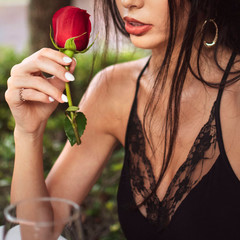attractive woman holding red rose