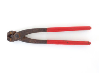 Aerial view old and rusty pliers with red handle in horizontal position isolated on white background. Close up of Old vintage rusty iron clamps.